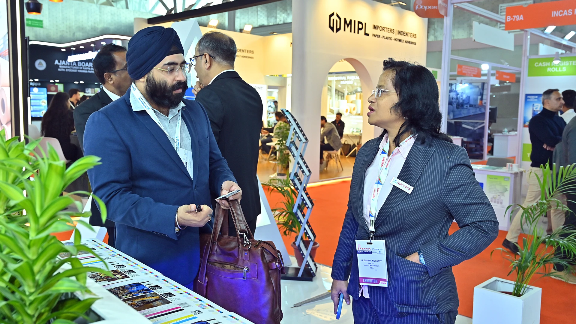 One-on-one B2B conversation at the Apcotex Paperex 2025 stall supported by branded brochures and collateral.